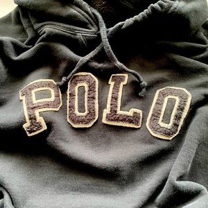 Black polo hoodie, white trim on the polo logo